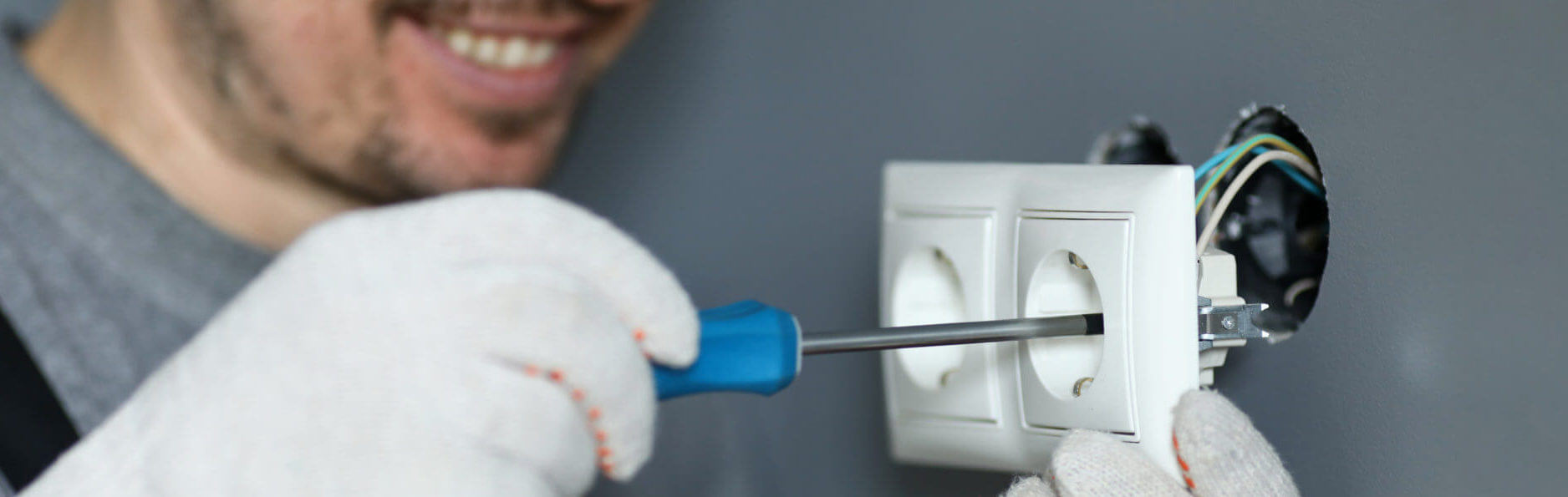 Handyman Using Screwdriver To Install Sockets