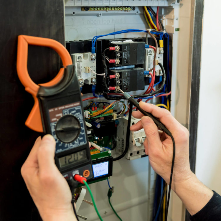 The Man Is Repairing The Switchboard Voltage With Automatic Switches.